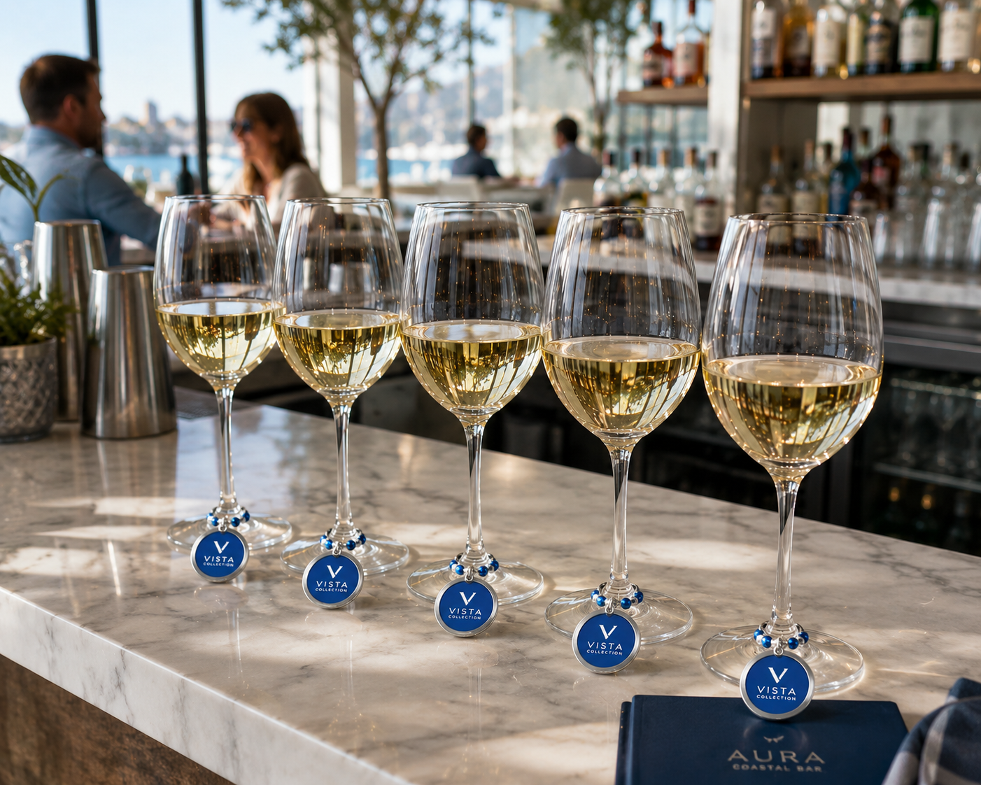 Custom company logo wine charm  with blue and silver beads on a white napkin at a corporate event table.