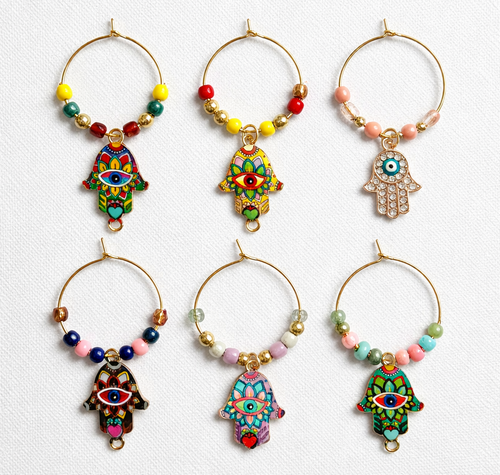 Set of six vibrant and colorful hamsa hand wine glass charms . Golden-tone hoops with coordinated beads.