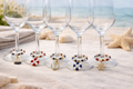 nauticl theme wine charms with buoys, anchors, sailboats in red, white and blue colors on gold tone hoops with coordinated beads 