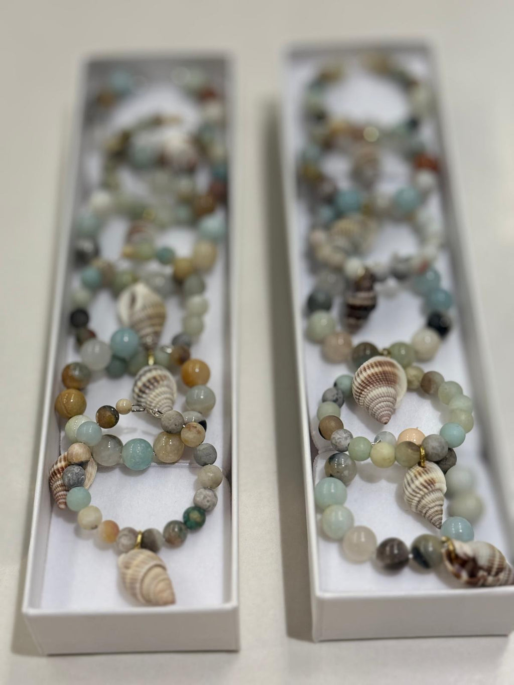 Sea green toned beaded napkin rings with sea shells. Sets of 6
