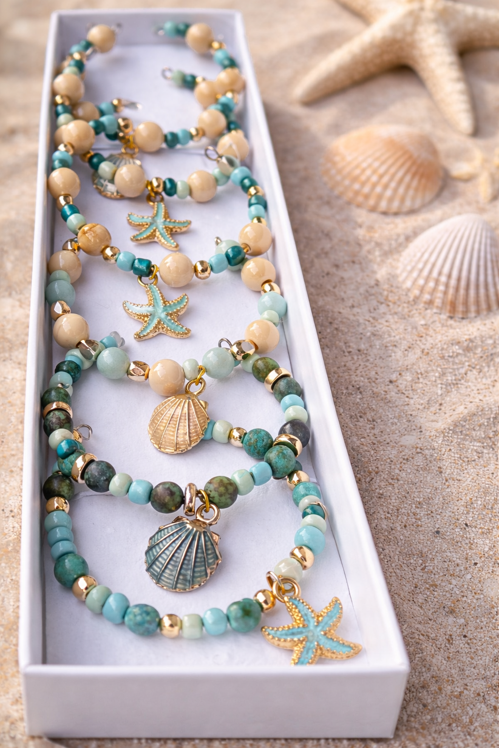 Sea shell napkin rings collection styled on white linen close-up