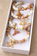 Pink sea collection napkin rings with rose beads styled on linen