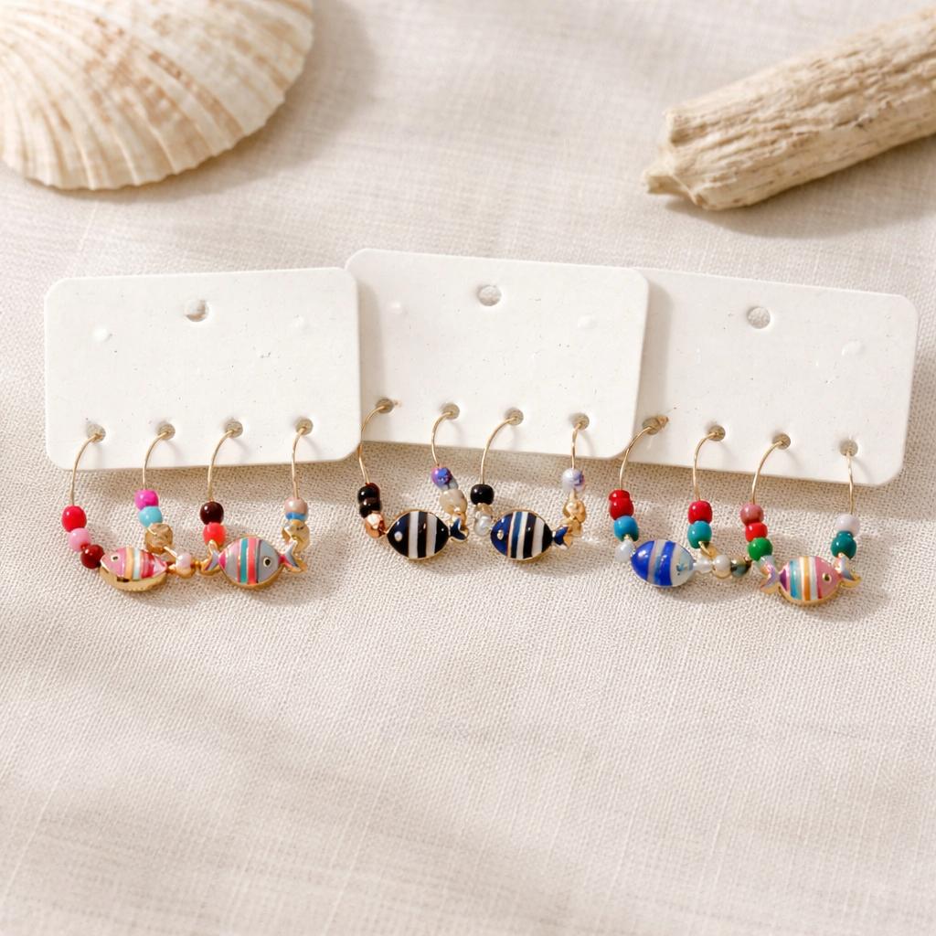 Fish pendant wine charms displayed on tablecloth set of 6