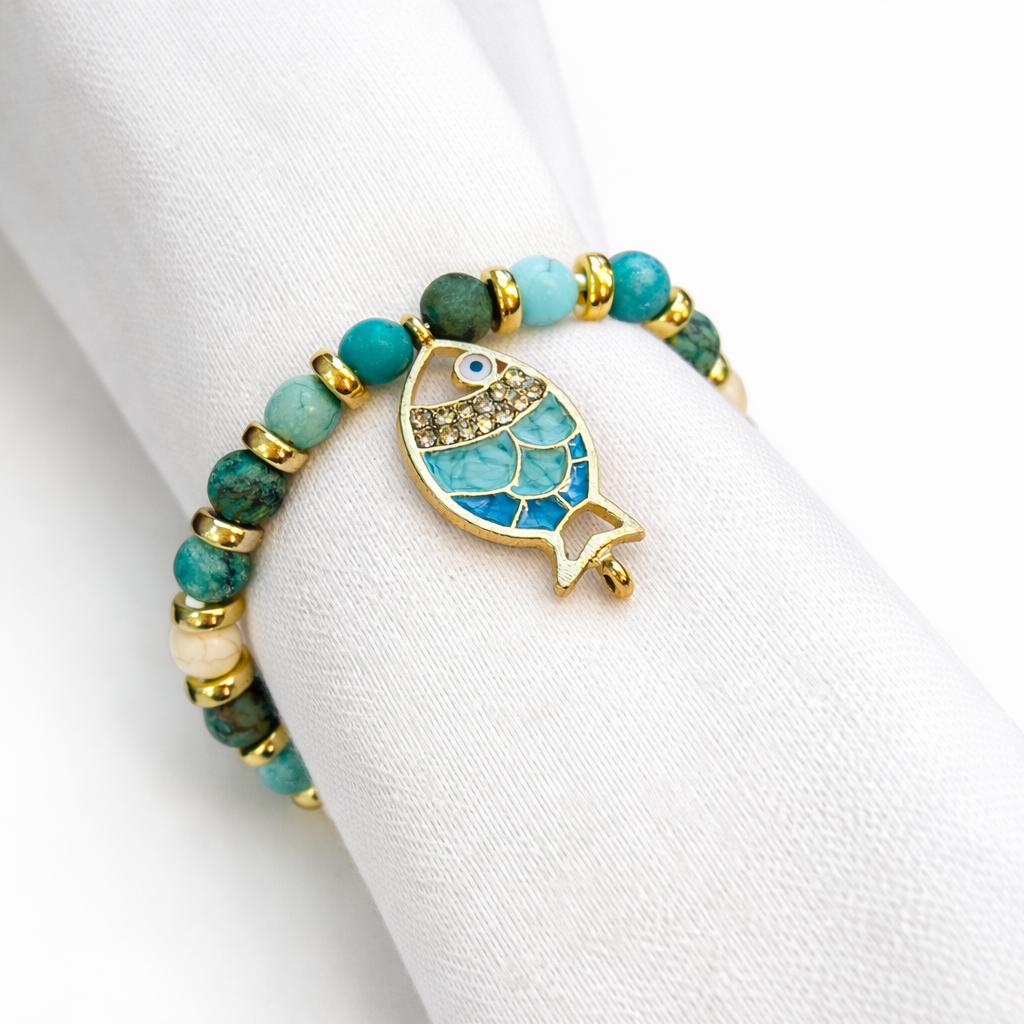 Fish napkin ring styled on white linen napkin with sea charm detail
