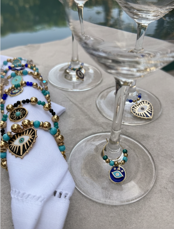 Hamsa wine charms and napkin rings styled together on table