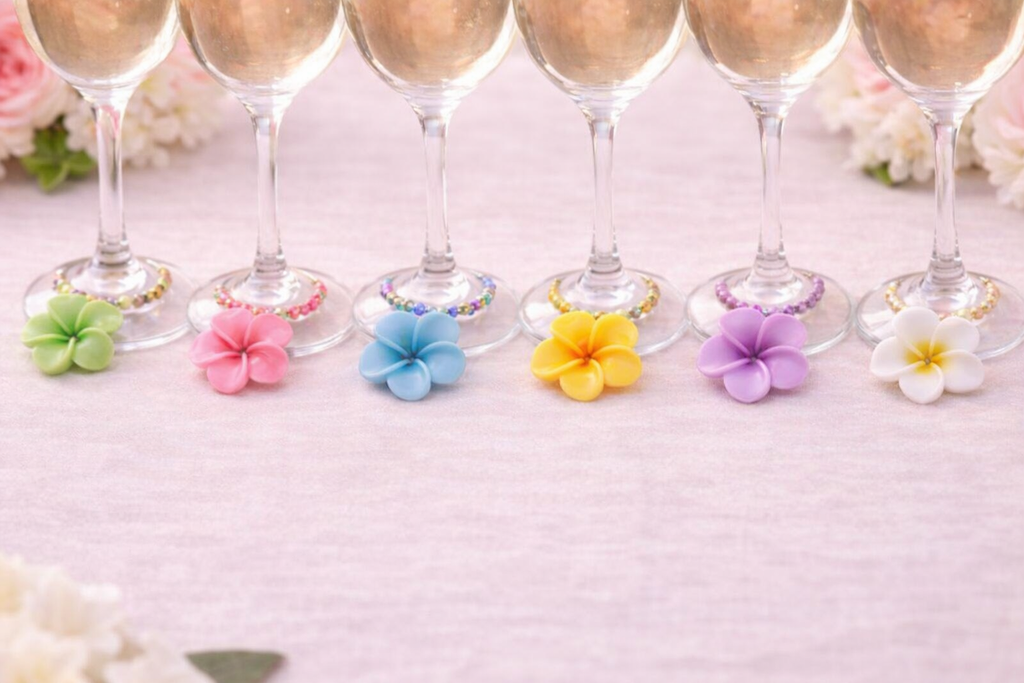 Colorful `Hawaiian flower wine glass charms on white linen table cloth set of 6