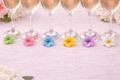 Colorful `Hawaiian flower wine glass charms on white linen table cloth set of 6