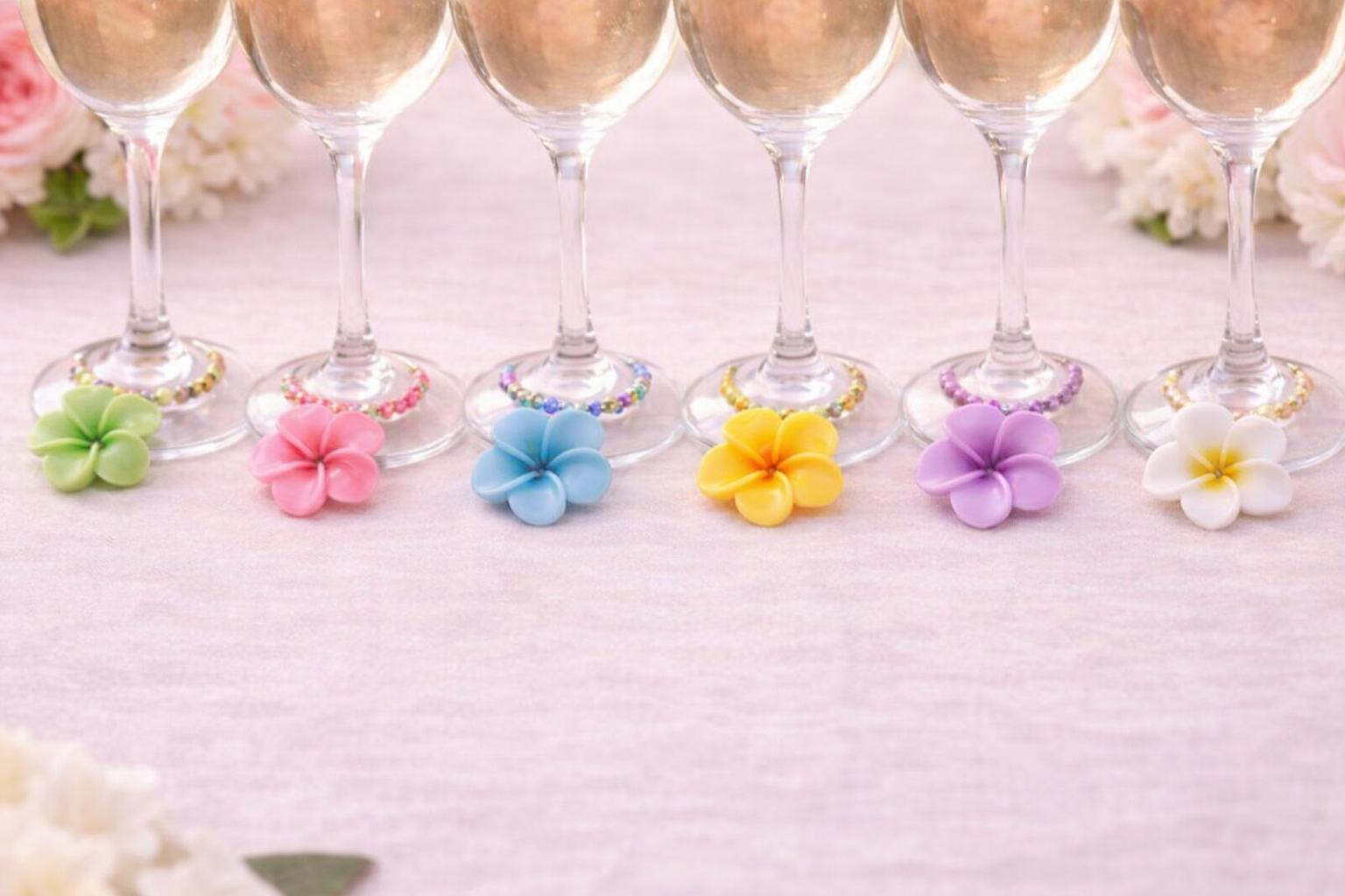 Colorful `Hawaiian flower wine glass charms on white linen table cloth set of 6