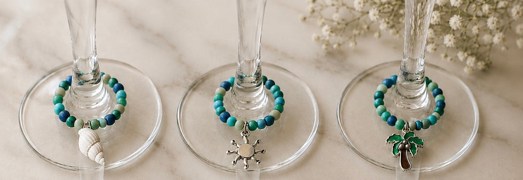 blue and turquoise beaded wine glass charms with sea elements - sea shells, sun, palm tree
