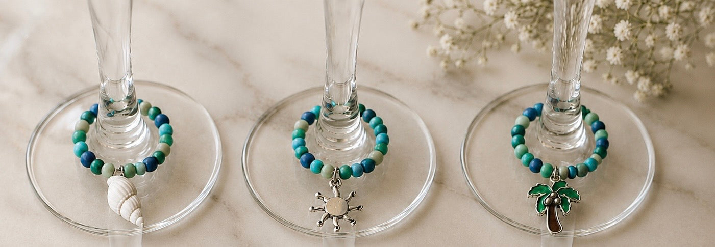 blue and turquoise beaded wine glass charms with sea elements - sea shells, sun, palm tree

