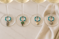 tropical elements with blue and turquoise beads and silver toned charms creating beautiful wine glass charms 
